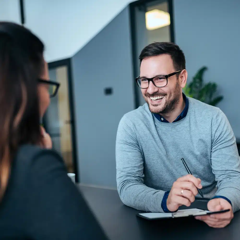 Staff having a friendly conversation during a meeting.