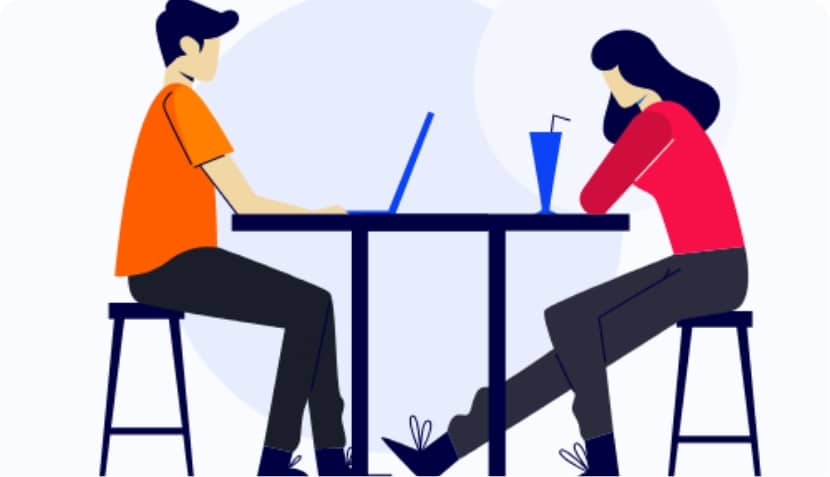 2 people sat opposite each other on a table.